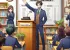 The principal of a school greeting and giving the morning announcements in the teachers' staff room in the morning before classes begin, anime style