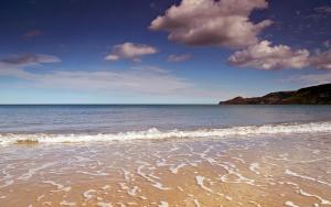 Beautiful picture of a beach with a few clouds