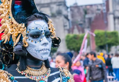 Woman in colorful skull makeup and costume for Mardi Gras