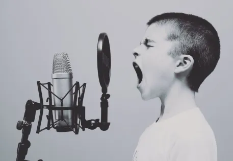 boy yellowing into a microphone