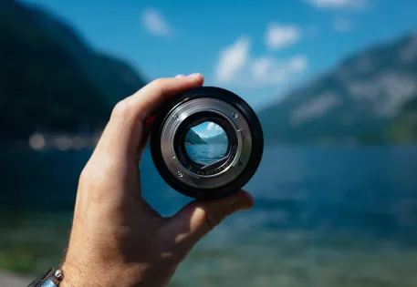 Looking through a spyglass at a scene of water and hills